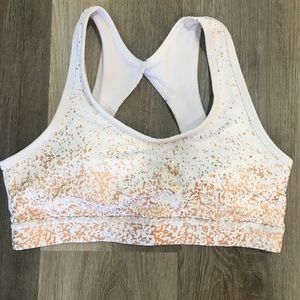 White sport bra with rose gold foil accent.